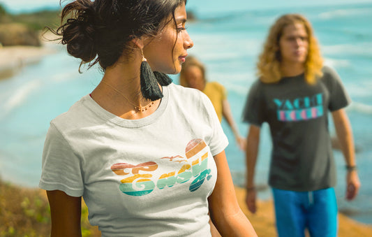 Woman wearing an "Easy" T-shirt on the beach with friends.